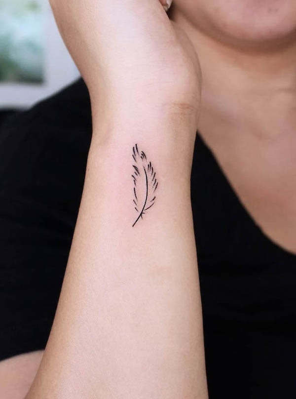 Minimalist feather wrist tattoo by @uhhhhtaco