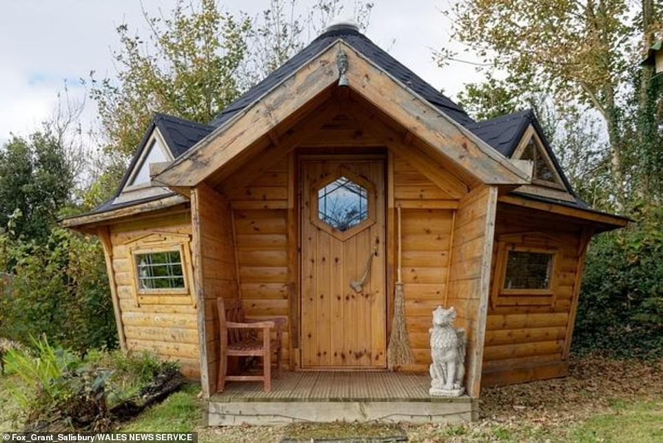 The property near Redberth, Pembrokeshire, comes with a UFO, two converted planes, a submarine and a speedboat in the garden (Pictured: a wooden cabin)