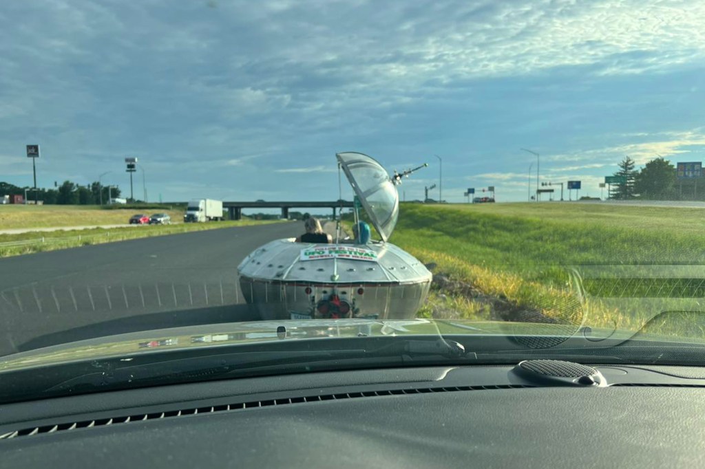 Unique alien-shaped car being pulled over on a road in Missouri