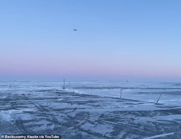 The military plane flies towards where the wreckage is believed to be in remote Alaska