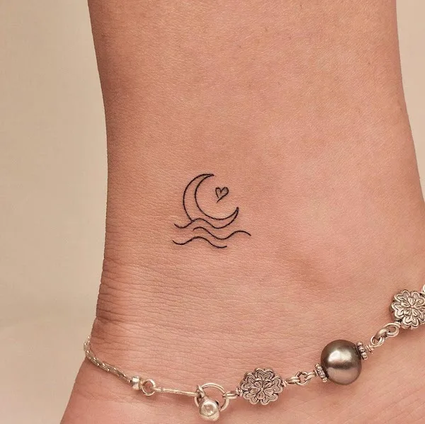 Small moon and ocean ankle tattoo by @tattooer_jina